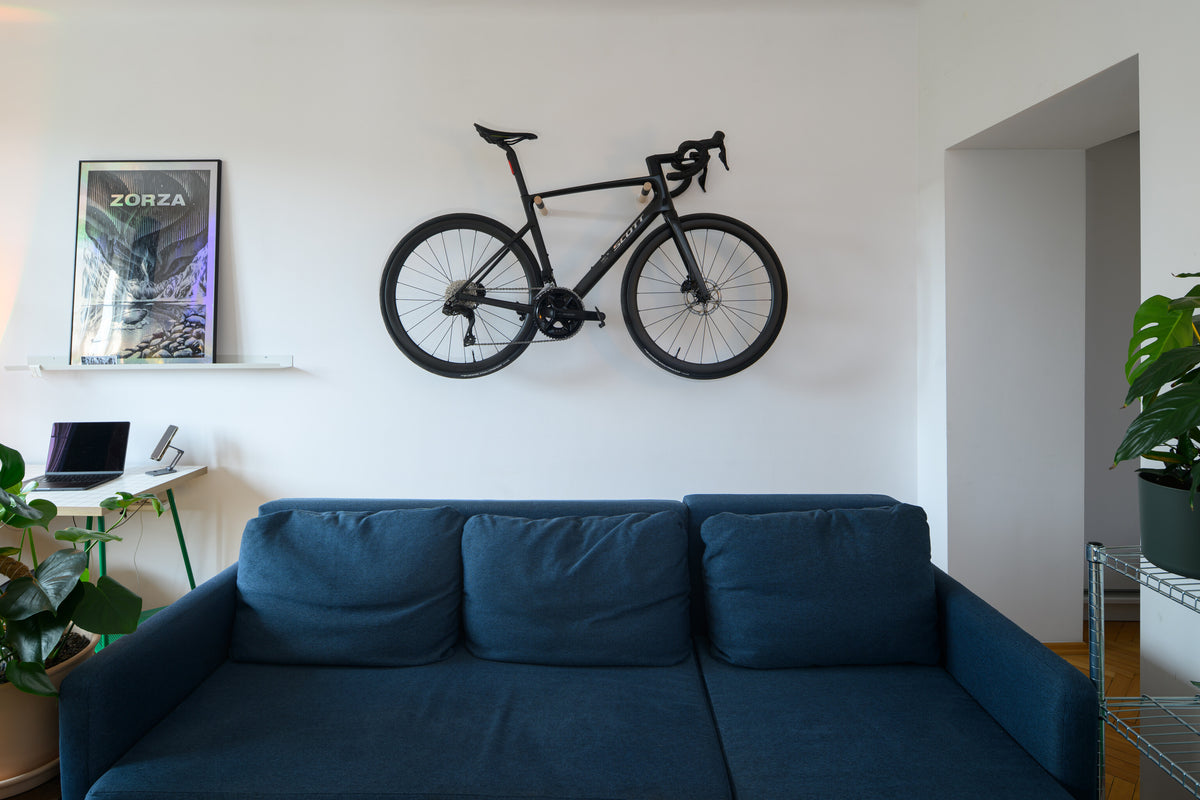 Bicycle hanging on wooden wall mount in apartment