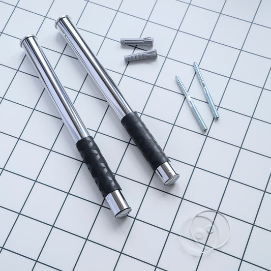 Metal bike wall mount with black rubber grip surface on a grid background

